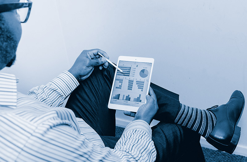 selling-a-business Selling a business. Person sitting on chair holding tablet. Photo by Adeolu Eletu on Unsplash.