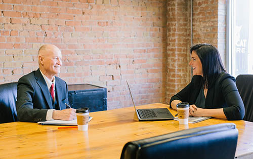 photo of two people in a conference room